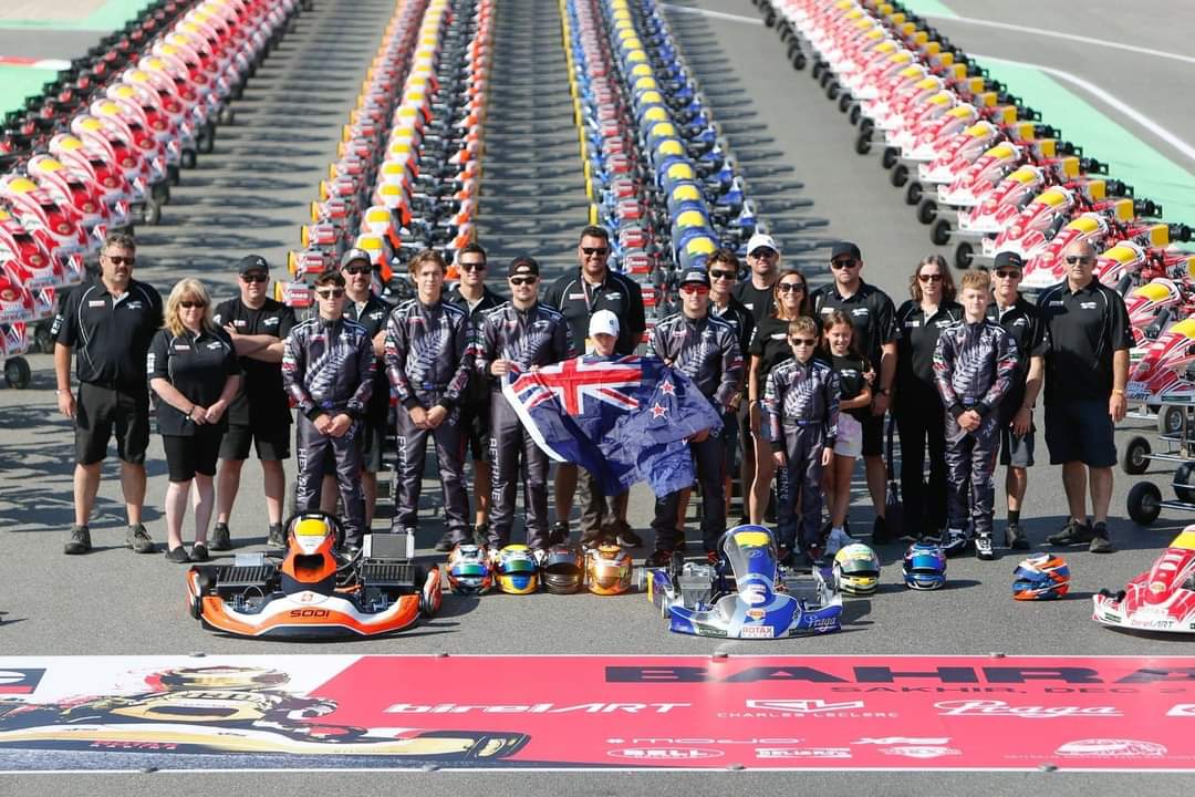 Team New Zealand karting squad with the national flag in Bahrain, 2023